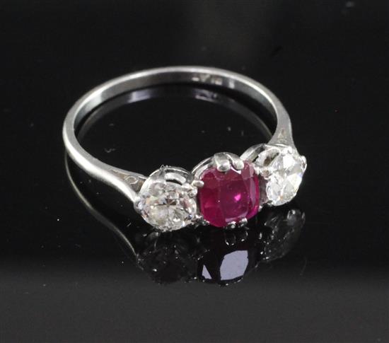 A mid 20th century platinum, ruby and diamond three stone ring, size O.